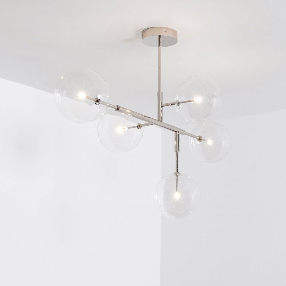 A dazzling polished nickel LED pendant with transparent glass lampshades