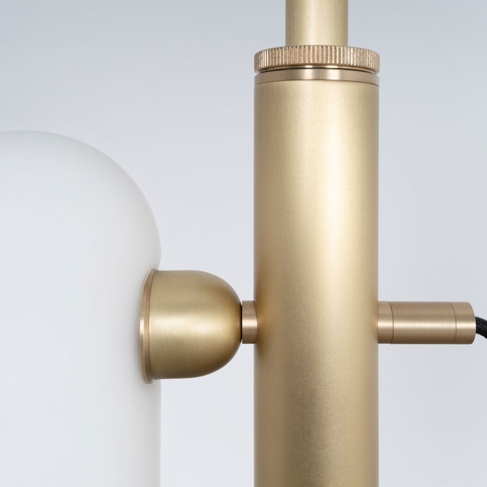 A glamorous industrial lacquered burnished brass floor lamp