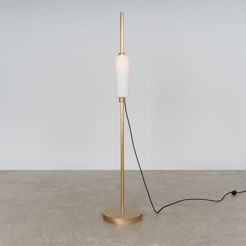 A glamorous industrial lacquered burnished brass floor lamp