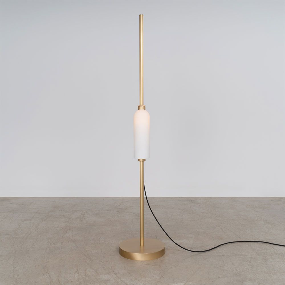A glamorous industrial lacquered burnished brass floor lamp