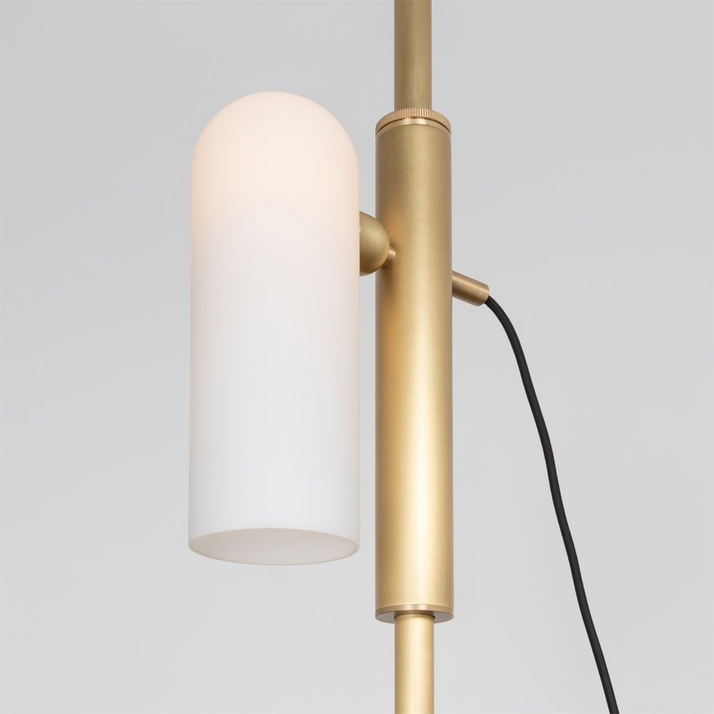 A glamorous industrial lacquered burnished brass floor lamp