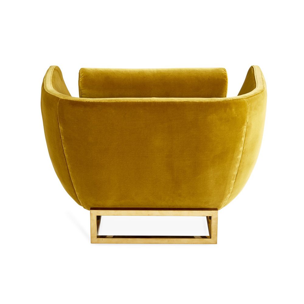 A luxurious golden-yellow velvet-upholstered lounge chair with a brushed brass base