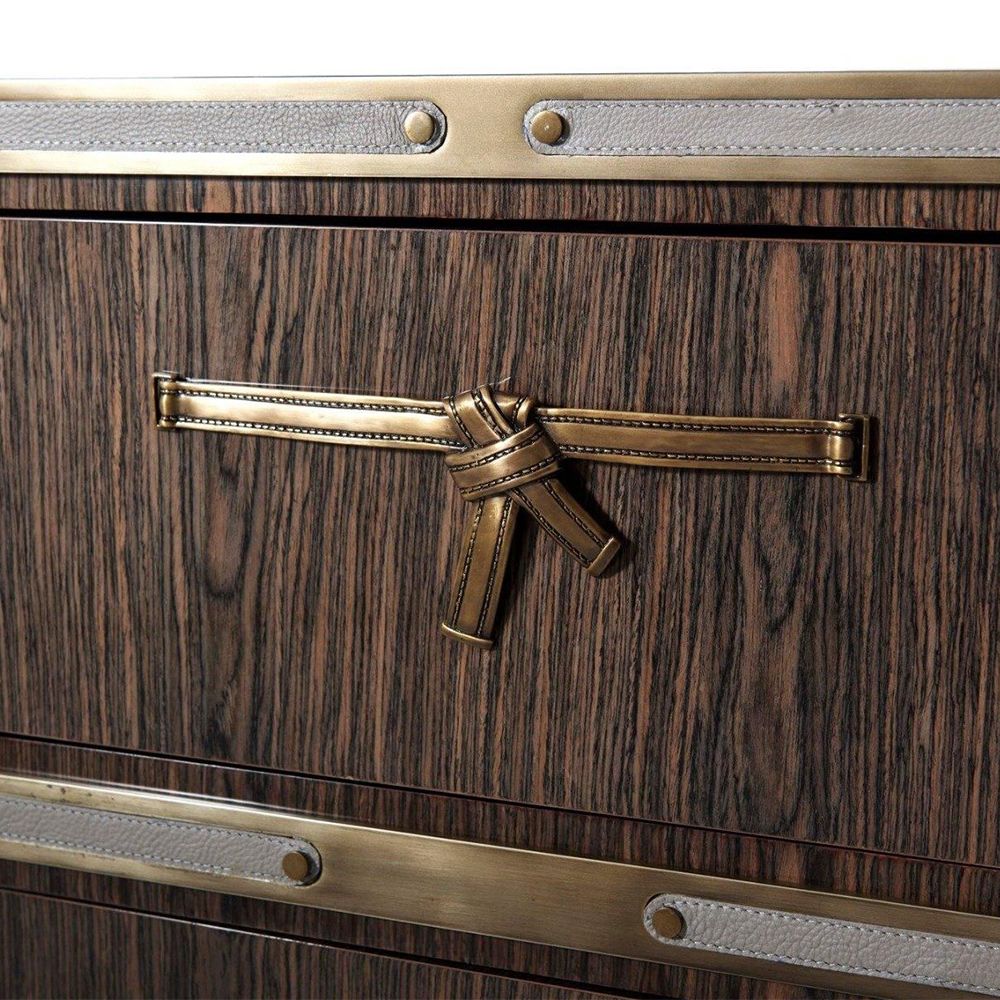 Sophisticated wooden chest with brass bow and leather details