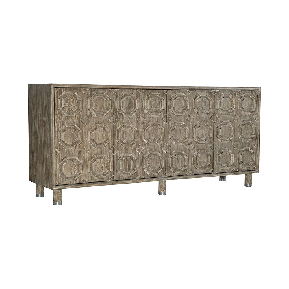 A textured wooden sideboard with four carved geometric patterned doors and finished with nickel plated aluminium legs