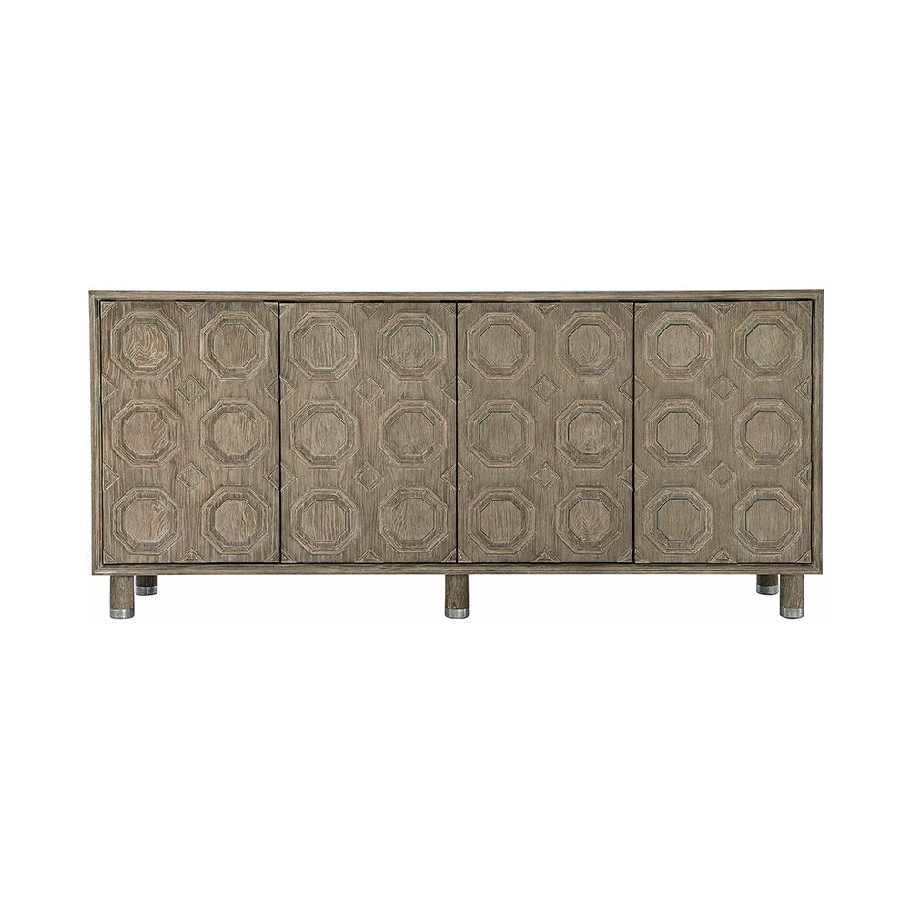 A textured wooden sideboard with four carved geometric patterned doors and finished with nickel plated aluminium legs