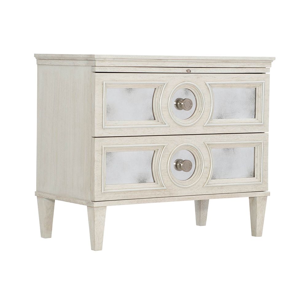 An elegant white oak veneer bedside table with two antiqued mirrored glass panel drawers, Silver Luster highlights and a Manor White finish