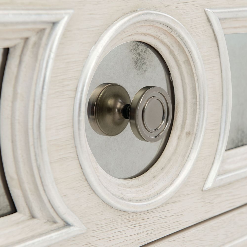 An elegant white oak veneer bedside table with two antiqued mirrored glass panel drawers, Silver Luster highlights and a Manor White finish