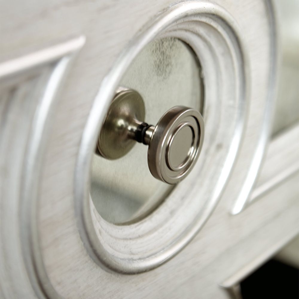 An elegant white oak veneer bedside table with two antiqued mirrored glass panel drawers, Silver Luster highlights and a Manor White finish