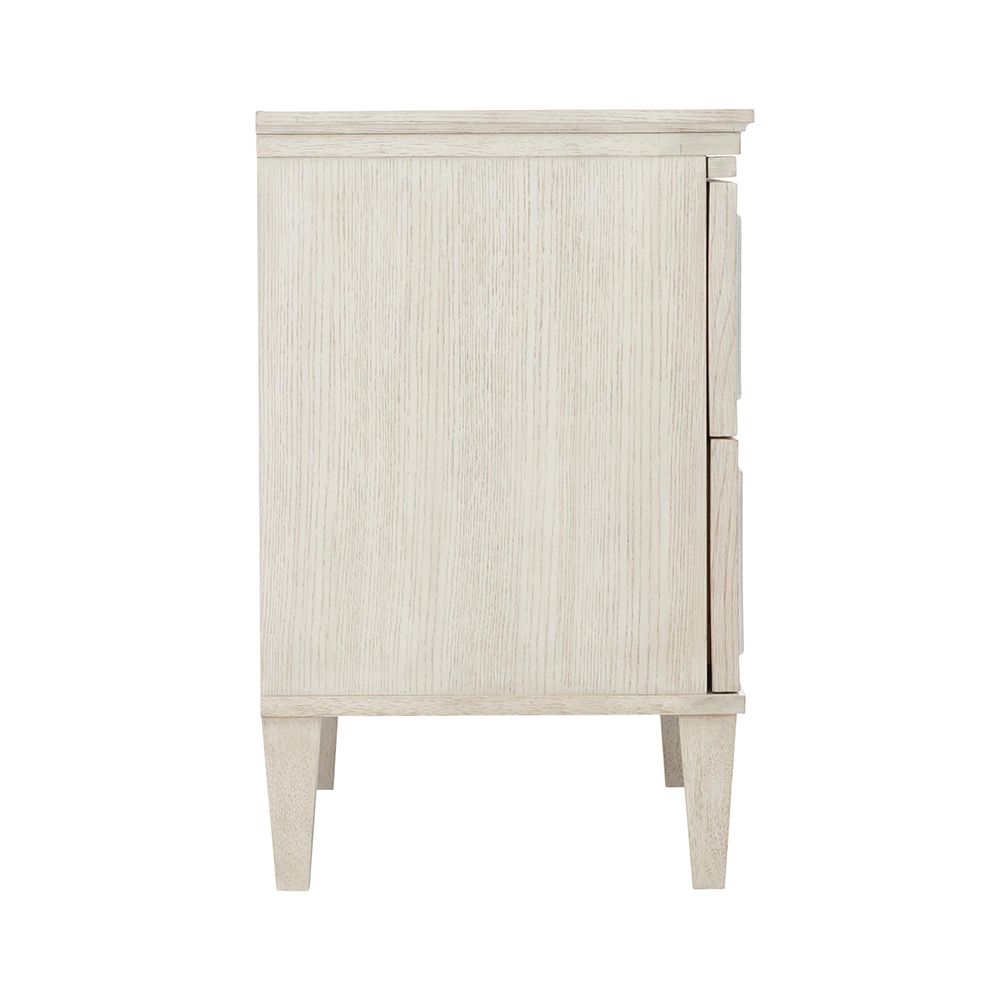 An elegant white oak veneer bedside table with two antiqued mirrored glass panel drawers, Silver Luster highlights and a Manor White finish