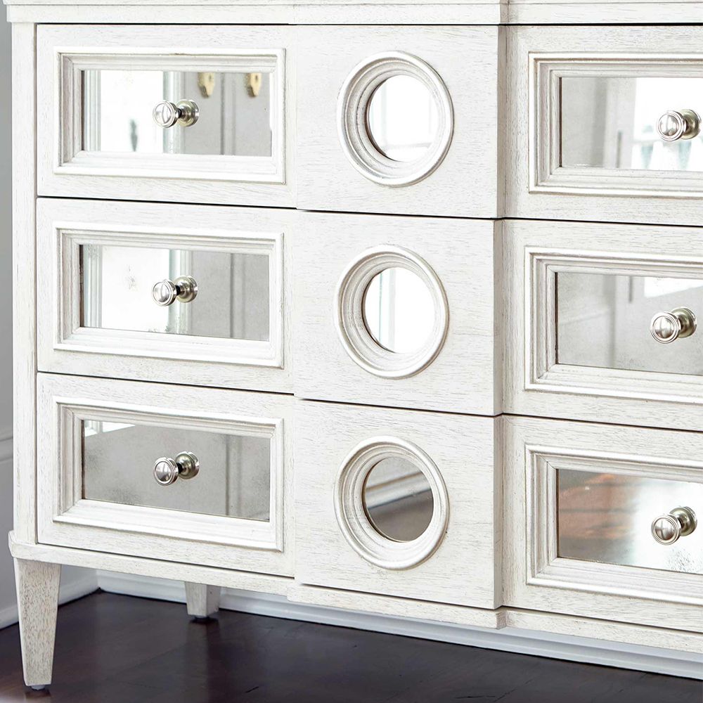 A luxury white oak veneer chest of drawers accentuated by antiqued mirrored glass panels with Silver Luster highlights and a Manor White finish