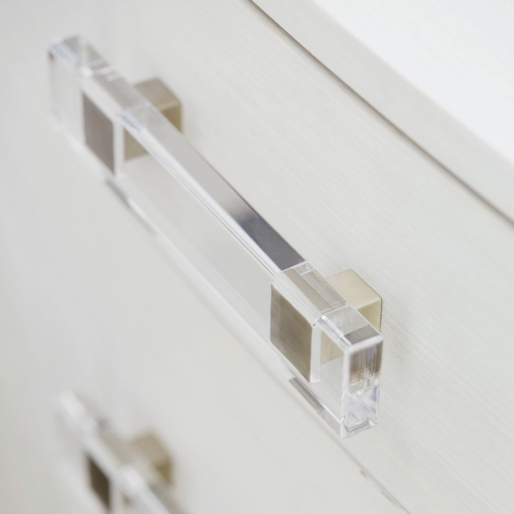 A sophisticated bedside table by Bernhardt featuring a grey and white finish and completed with three spacious drawers