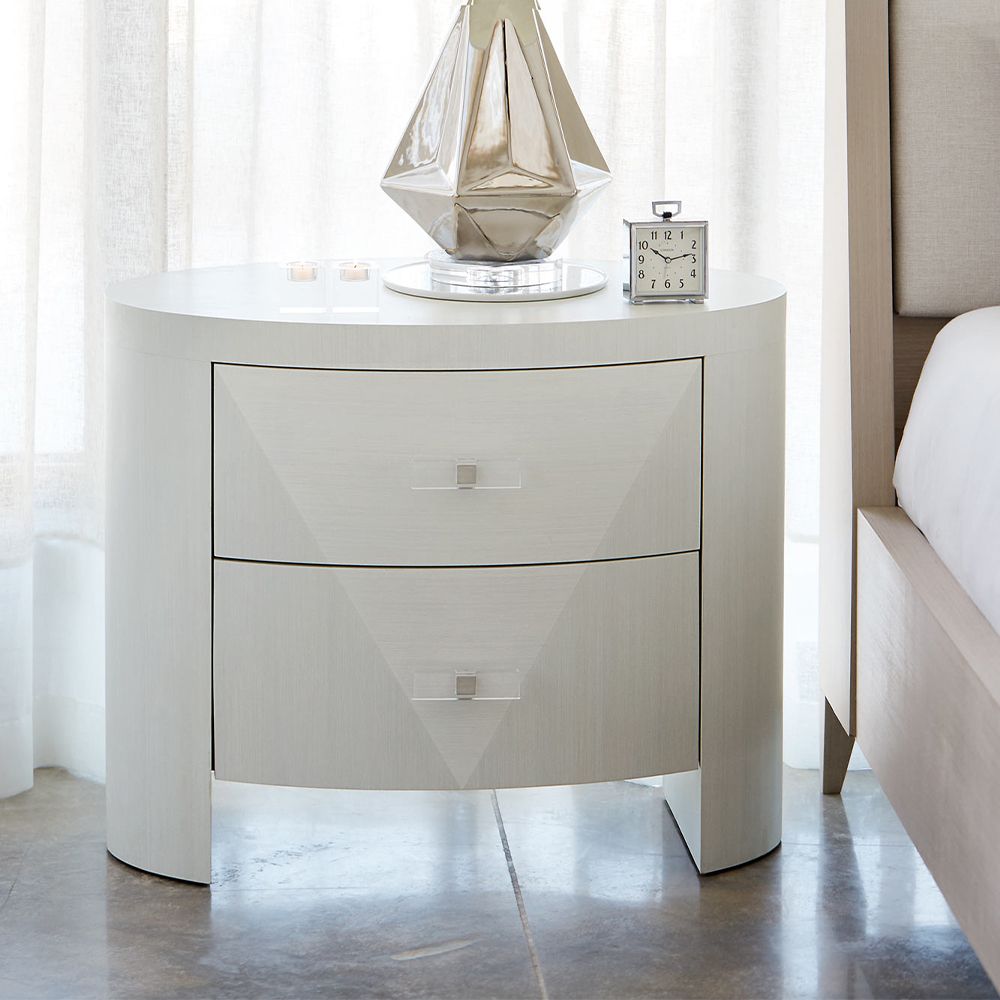 A unique and sophisticated oval bedside table by Bernhardt with two spacious drawers and a lovely white veneer finish