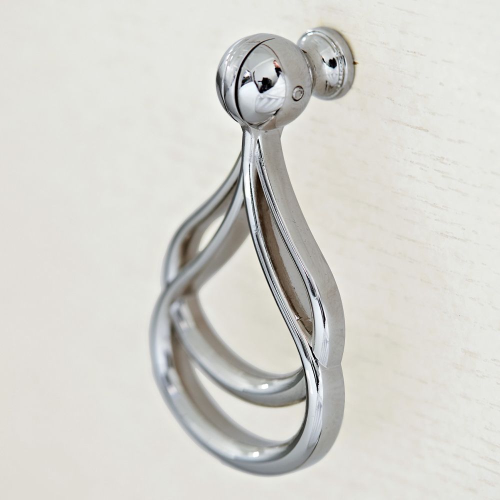 A contemporary entertainment unit with polished stainless steel accents, four drawers, two doors and internal shelving