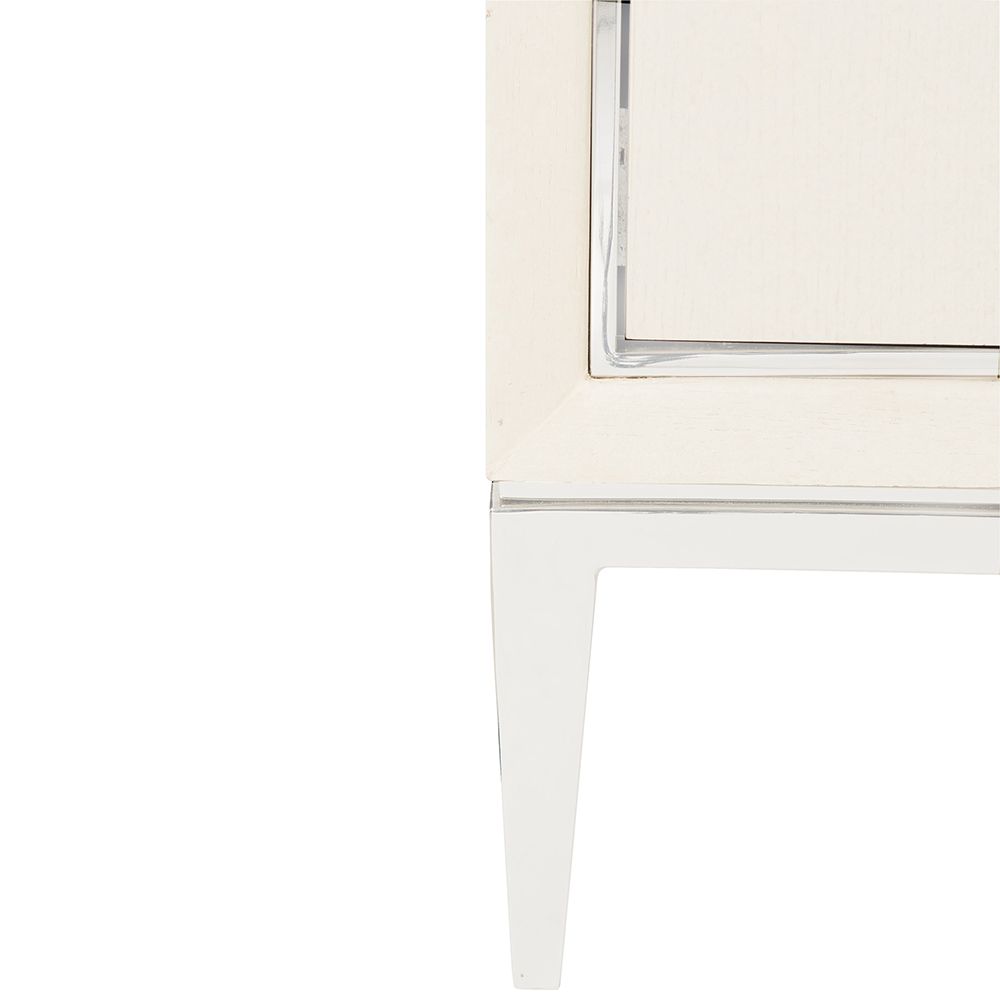 A contemporary entertainment unit with polished stainless steel accents, four drawers, two doors and internal shelving