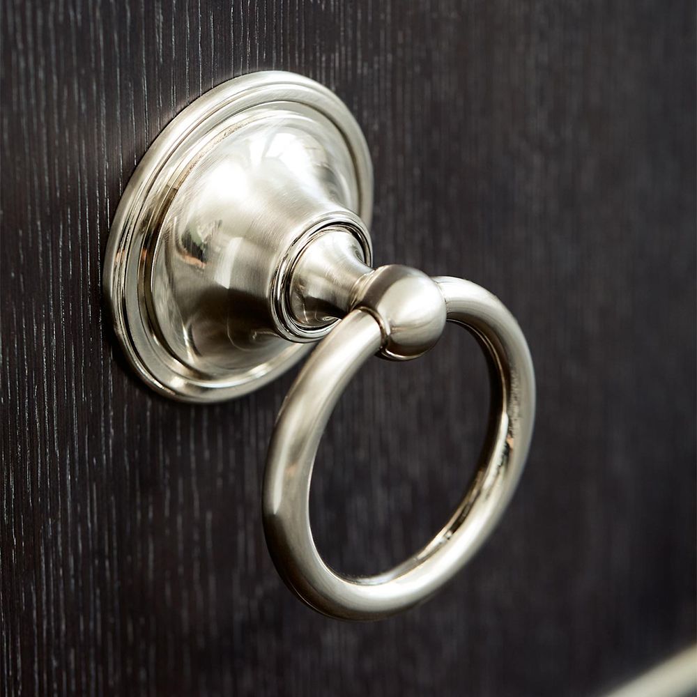 An elegant three door sideboard with a dark brown wooden finish and stylish stainless steel accents