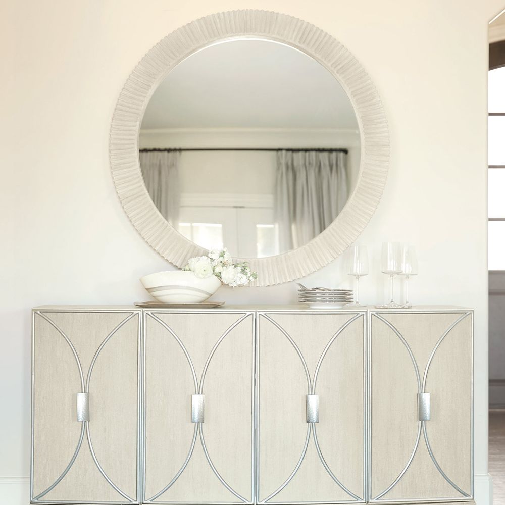 A contemporary round mirror by Bernhardt with a coastal style wooden frame 
