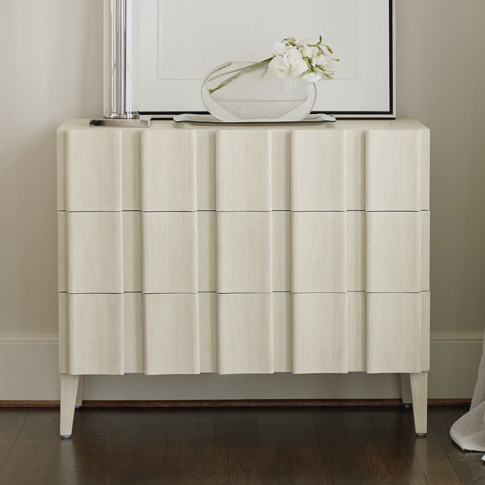 A unique three drawer chest by Bernhardt with shaped vertical overlays and a beautiful natural aged wood finish