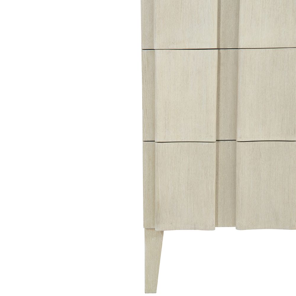 A unique three drawer chest by Bernhardt with shaped vertical overlays and a beautiful natural aged wood finish