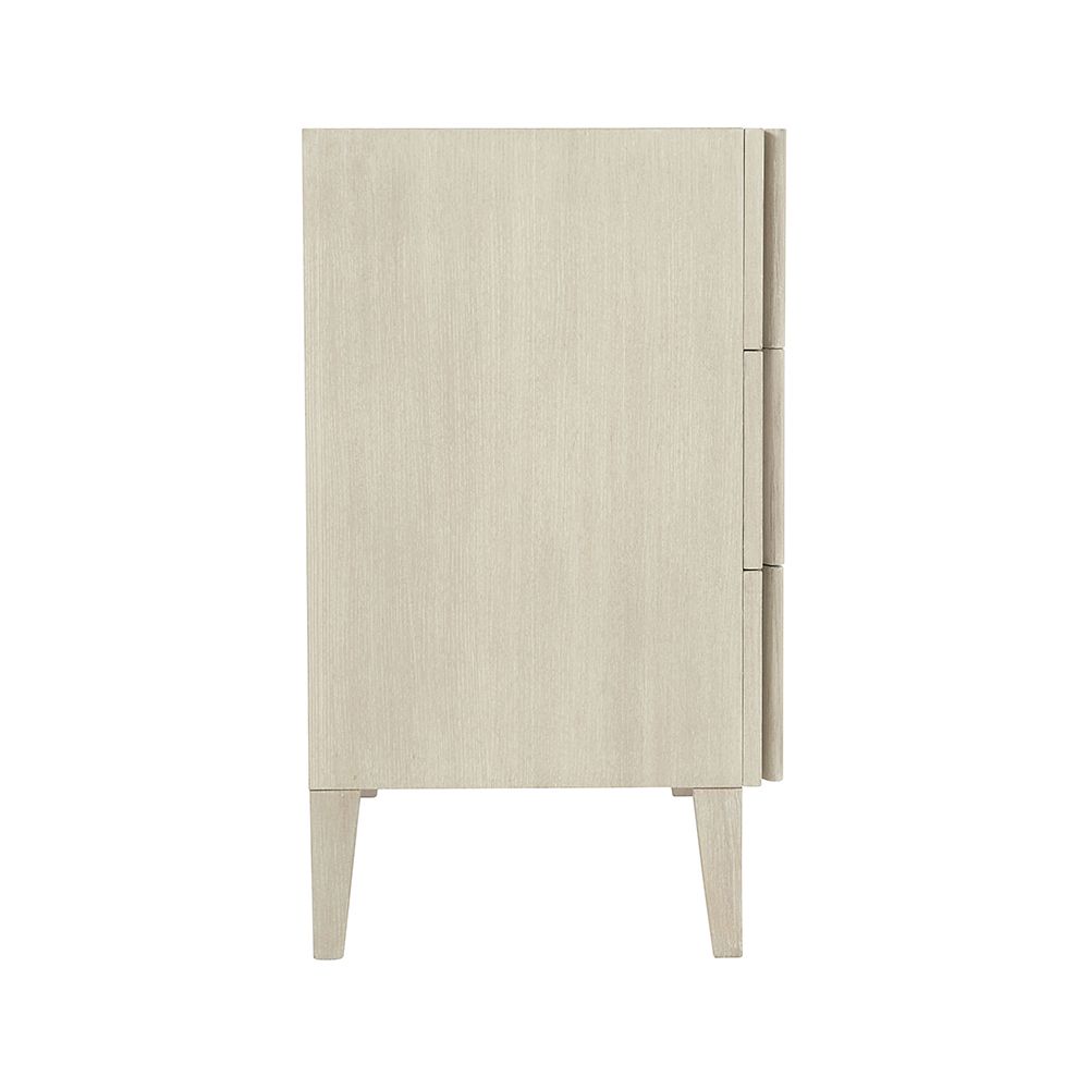 A unique three drawer chest by Bernhardt with shaped vertical overlays and a beautiful natural aged wood finish