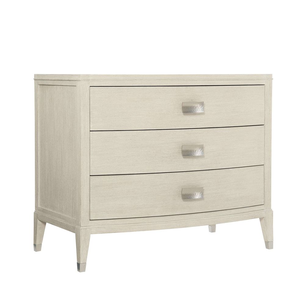 A chic minimal natural wood bedside table with tarnished nickel accents