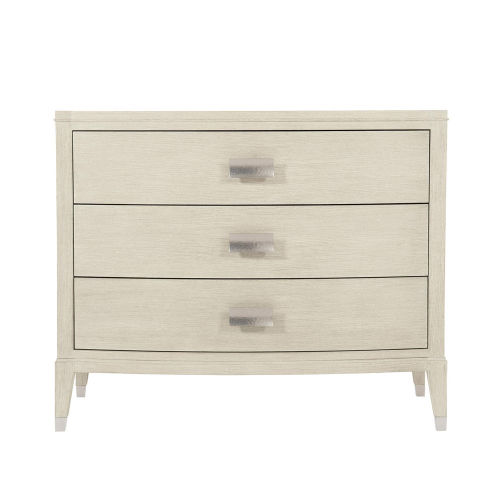 A chic minimal natural wood bedside table with tarnished nickel accents