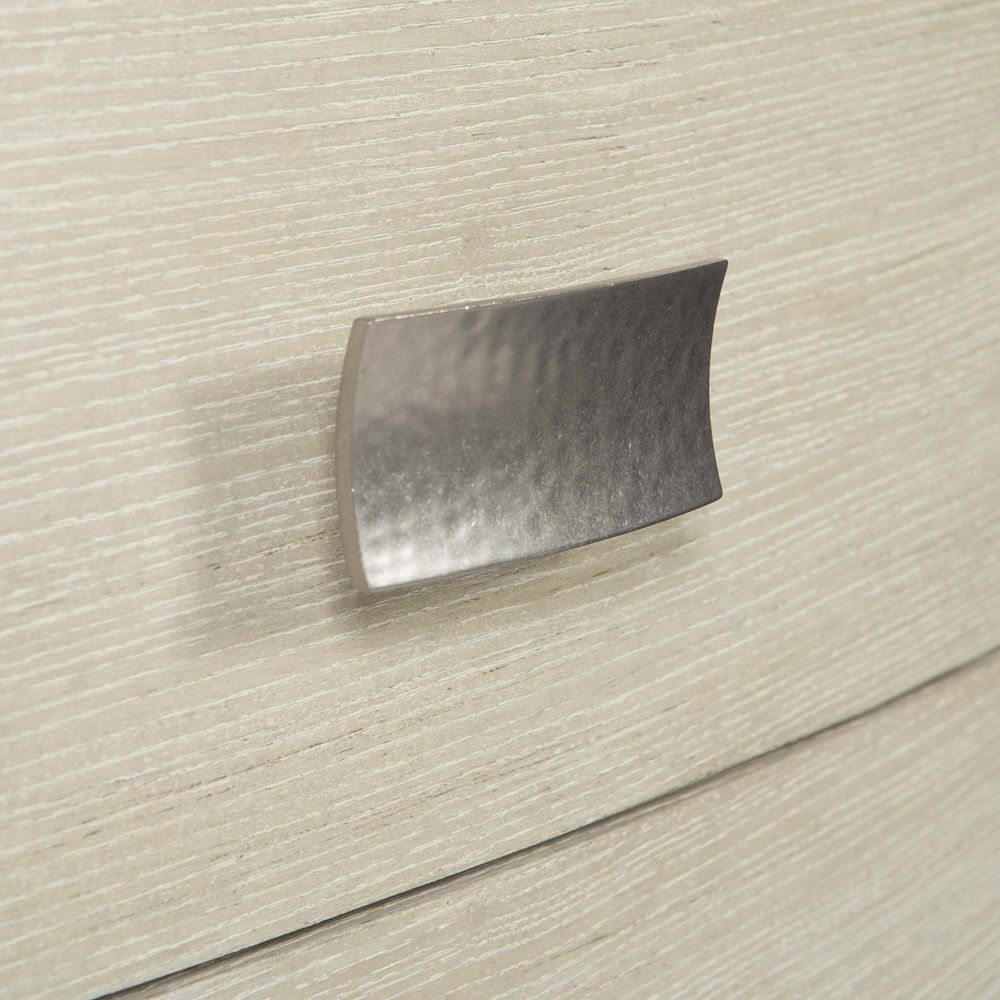 A chic minimal natural wood bedside table with tarnished nickel accents