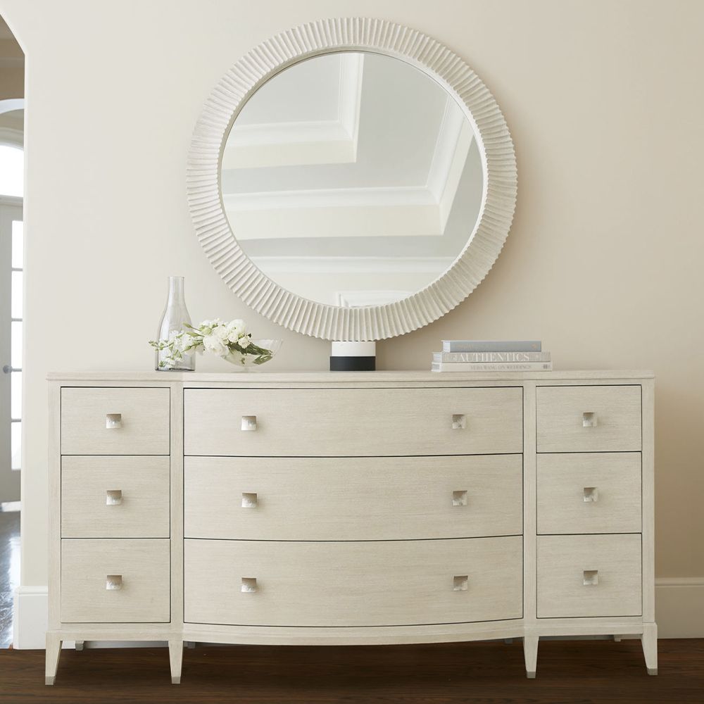 A contemporary round mirror by Bernhardt with a coastal style wooden frame 