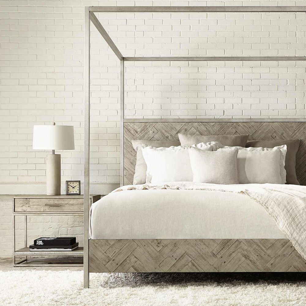 A wooden one-drawer bedside table featuring a steel base with a glazed silver finish and a bottom wooden shelf
