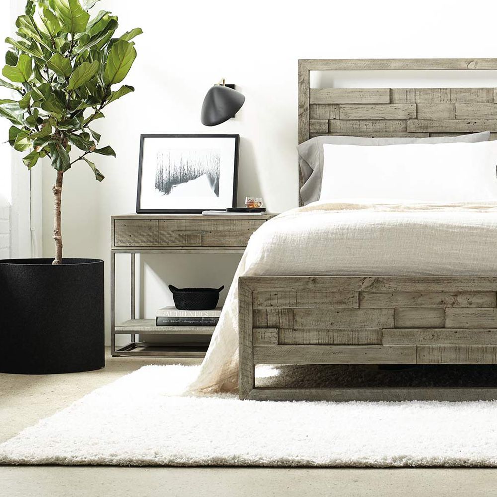 A wooden one-drawer bedside table featuring a steel base with a glazed silver finish and a bottom wooden shelf