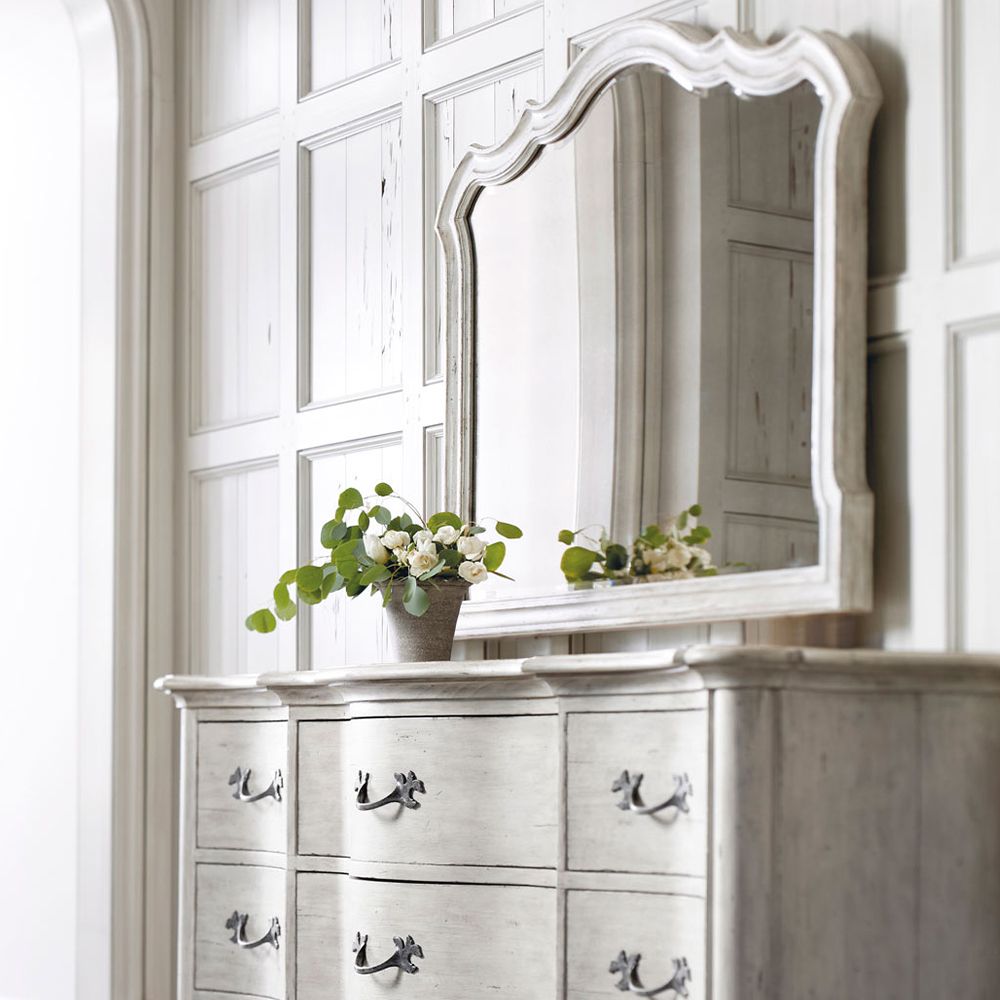 A beautiful antique mirror from Bernhardt with a bevelled mirrored edge and classic white frame 