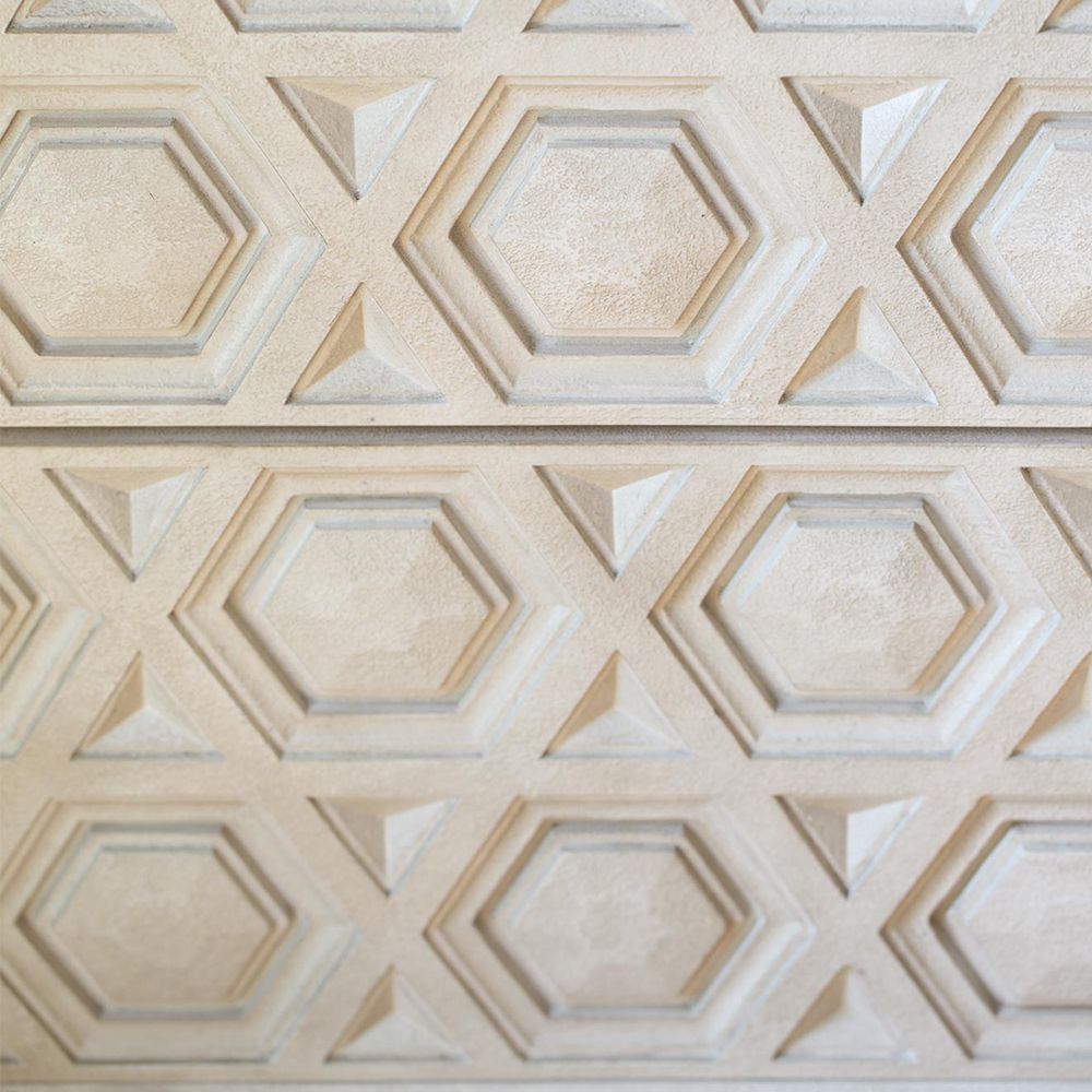 A unique two drawer chest of drawers from Bernhardt with a textured geometric design and stainless steel base with a nickel finish 