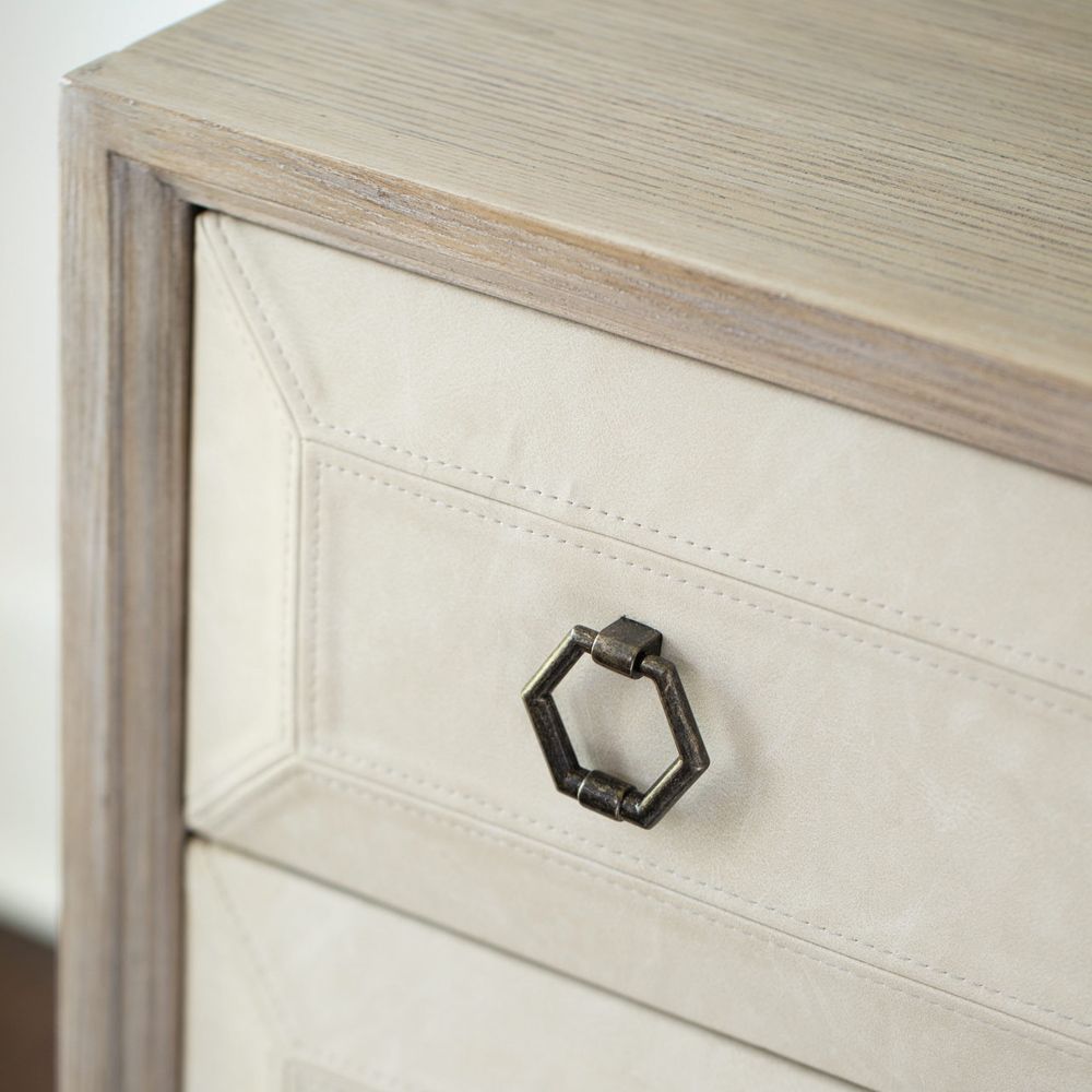 A stylish natural wood bedside table with performance fabric and tarnished nickel handles 