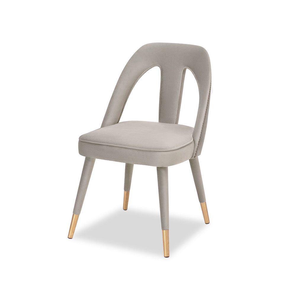 A luxury dining chair by Liang & Eimil with a gorgeous grey upholstery and brass detailing