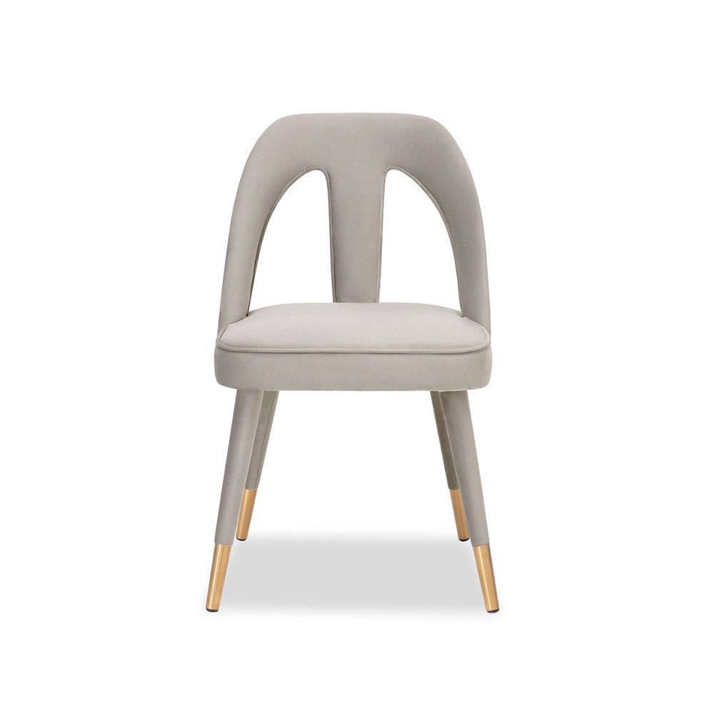 A luxury dining chair by Liang & Eimil with a gorgeous grey upholstery and brass detailing