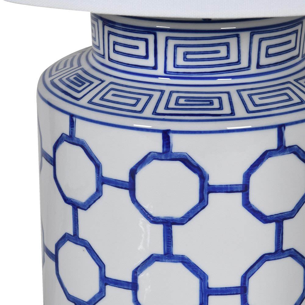 A Grecian-inspired table lamp with a white linen shade