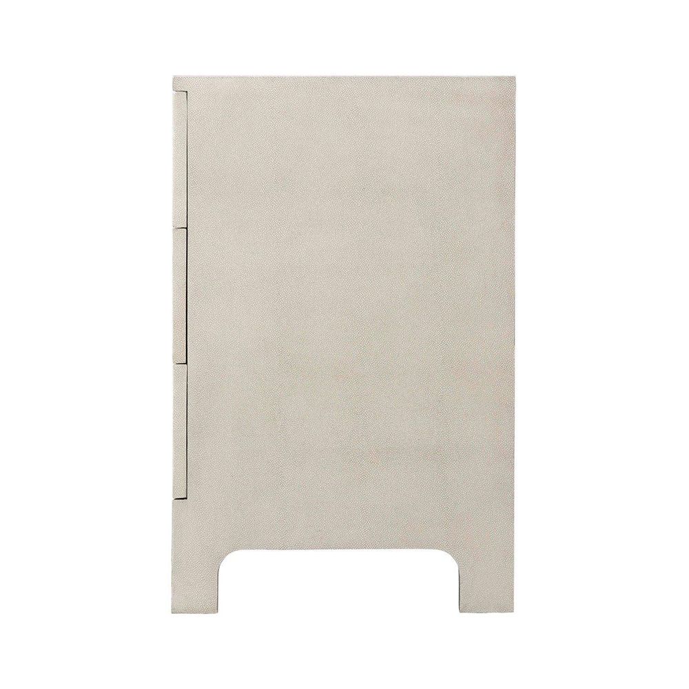 A luxurious chest of drawers with an undulating design, shagreen-embossed leather wrapping and nickel details  