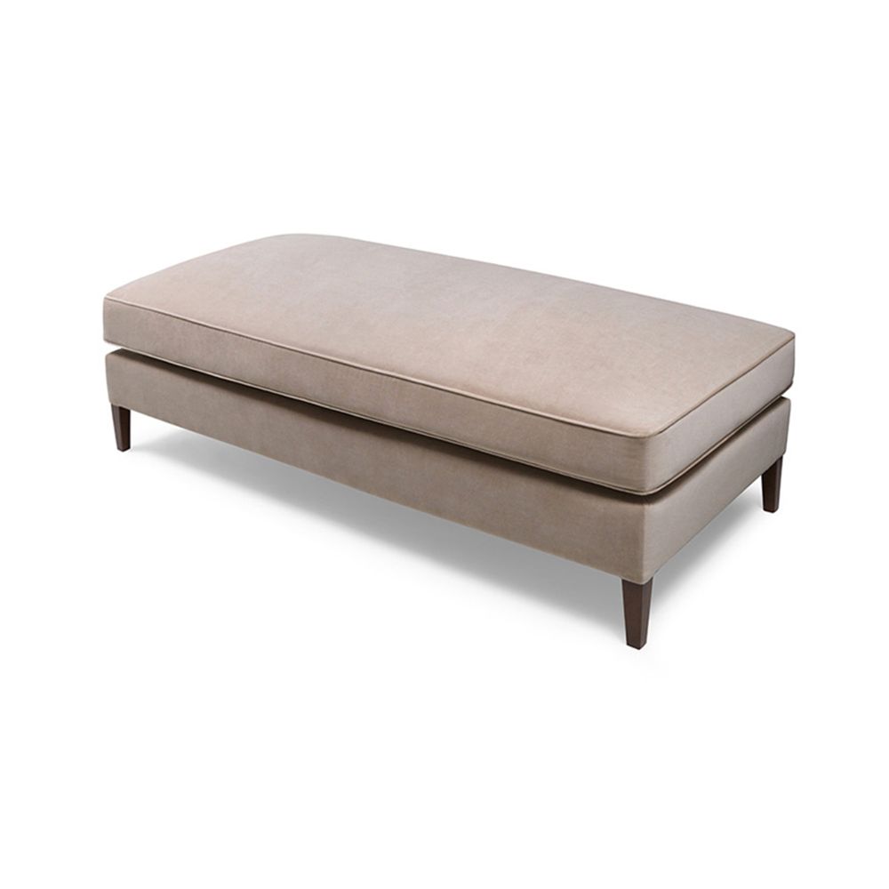 A contemporary bench with wooden legs and custom upholstery