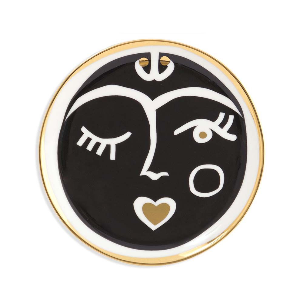 A luxurious set of four porcelain coasters with black, white and gold face designs