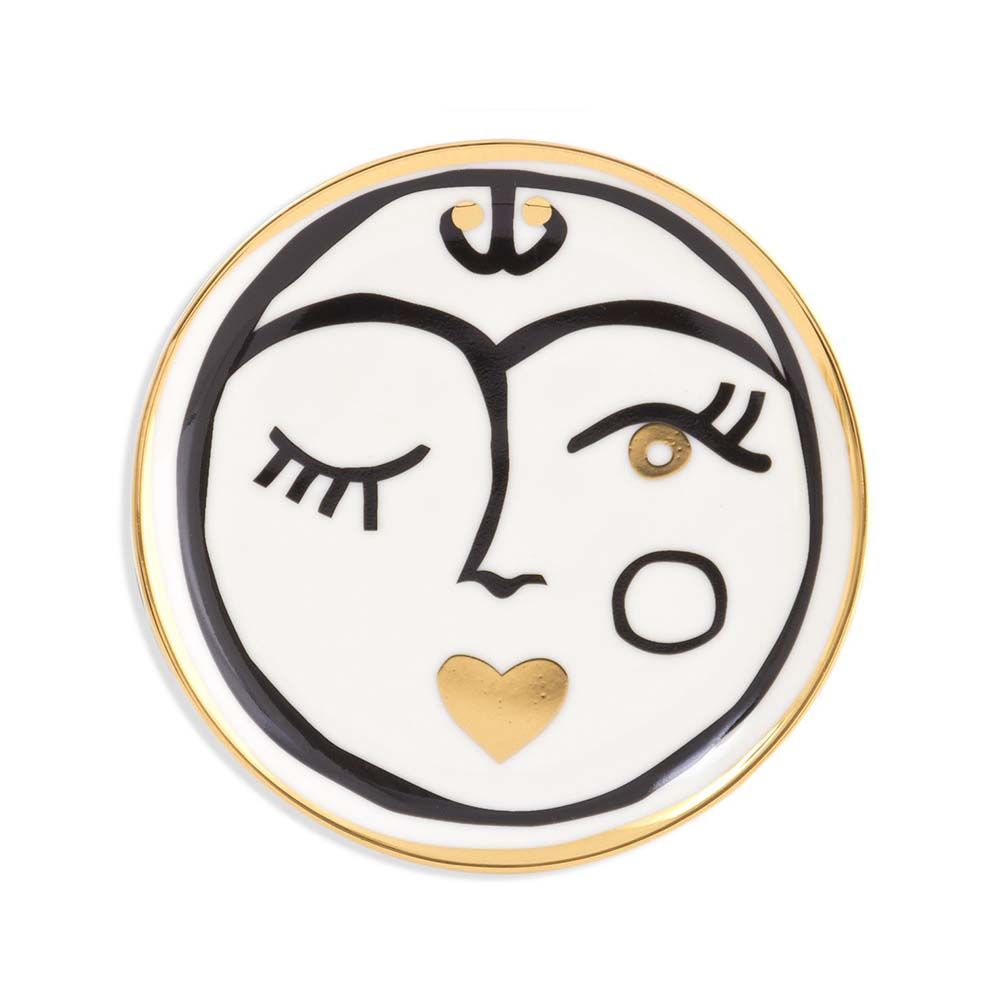 A luxurious set of four porcelain coasters with black, white and gold face designs