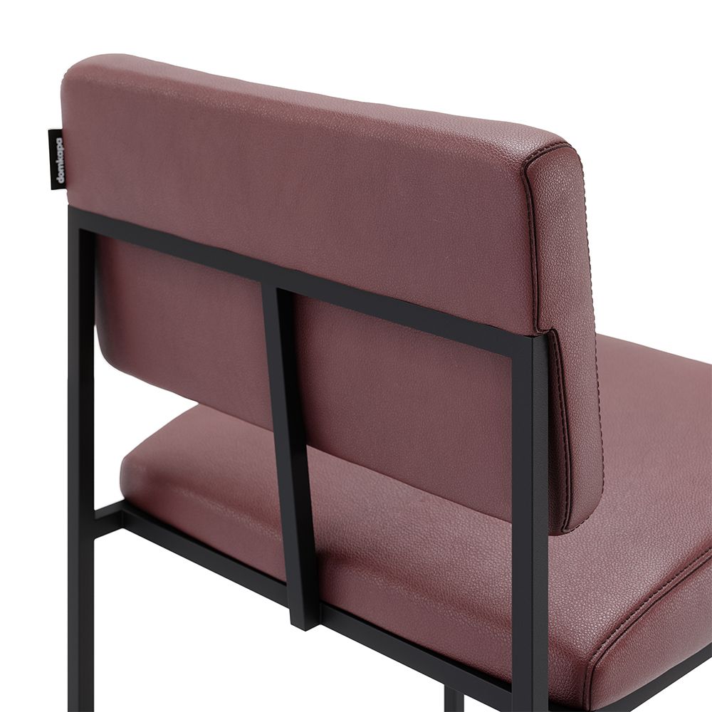 A luxurious modern counter stool with a minimal black metal frame and natural leather upholstery