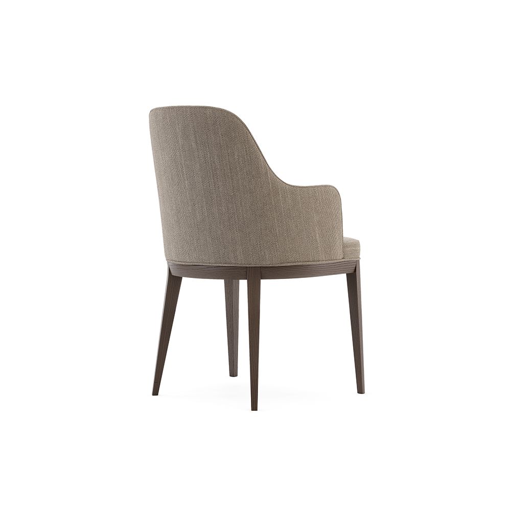 A sophisticated and stylish chair by Domkapa with a luxury upholstery and dark wooden frame
