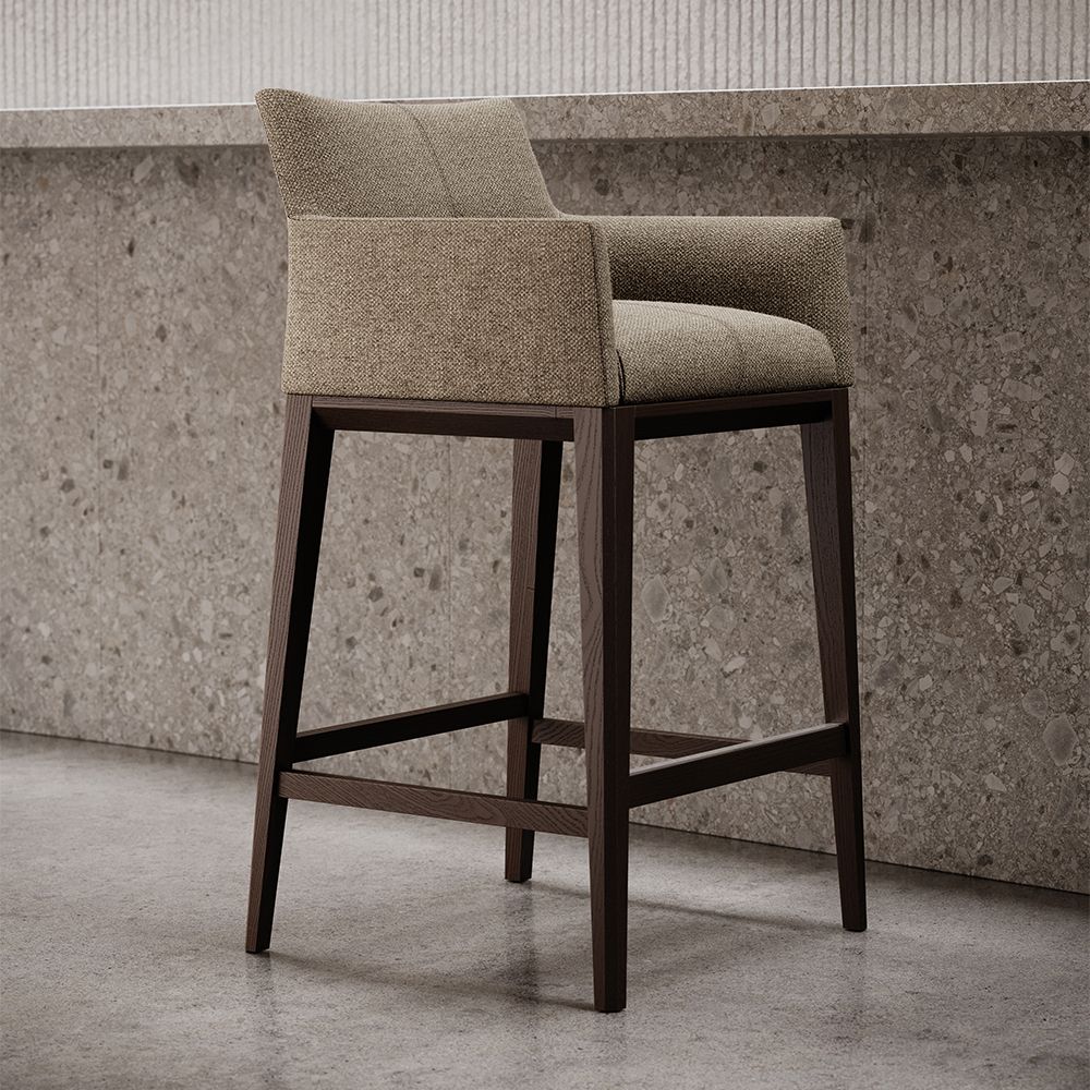 A sophisticated bar stool by Domkapa with a luxury upholstery and solid wood structure