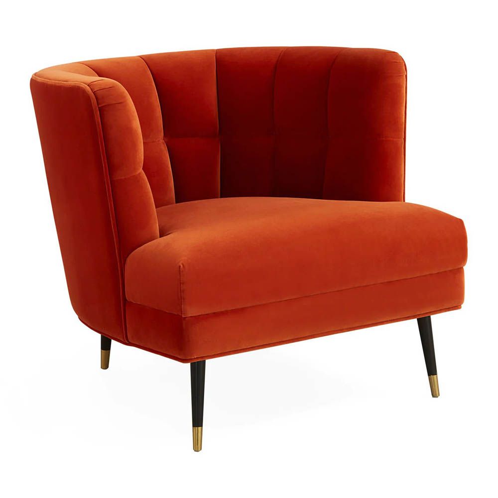 A luxury armchair by Jonathan Adler with a gorgeous red upholstery and beautiful brass capped feet