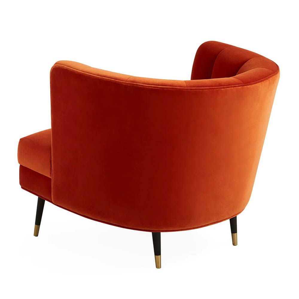 A luxury armchair by Jonathan Adler with a gorgeous red upholstery and beautiful brass capped feet