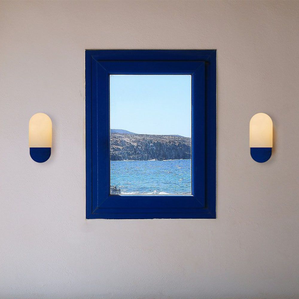 Sculpted wall sconce with a deep blue fixture and a frosted glass shade