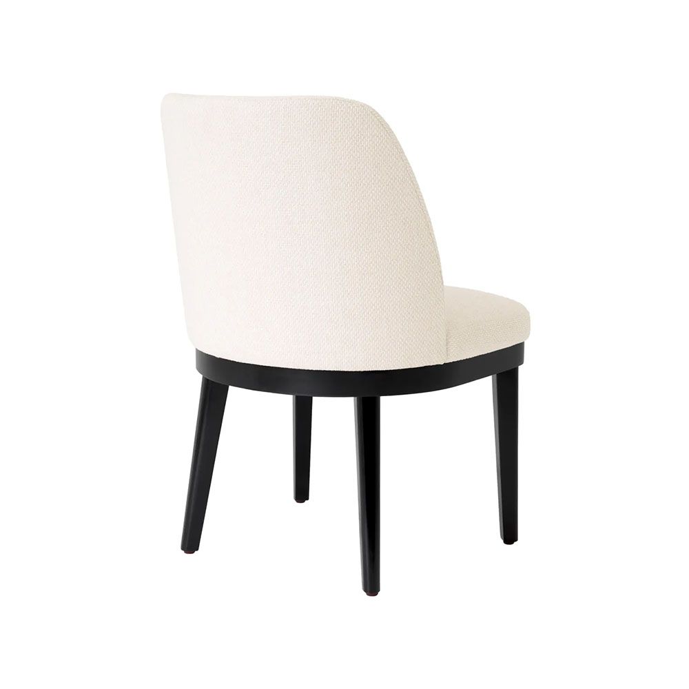 A stylish dining chair with a luxury Pausa Natural upholstery and sophisticated black frame