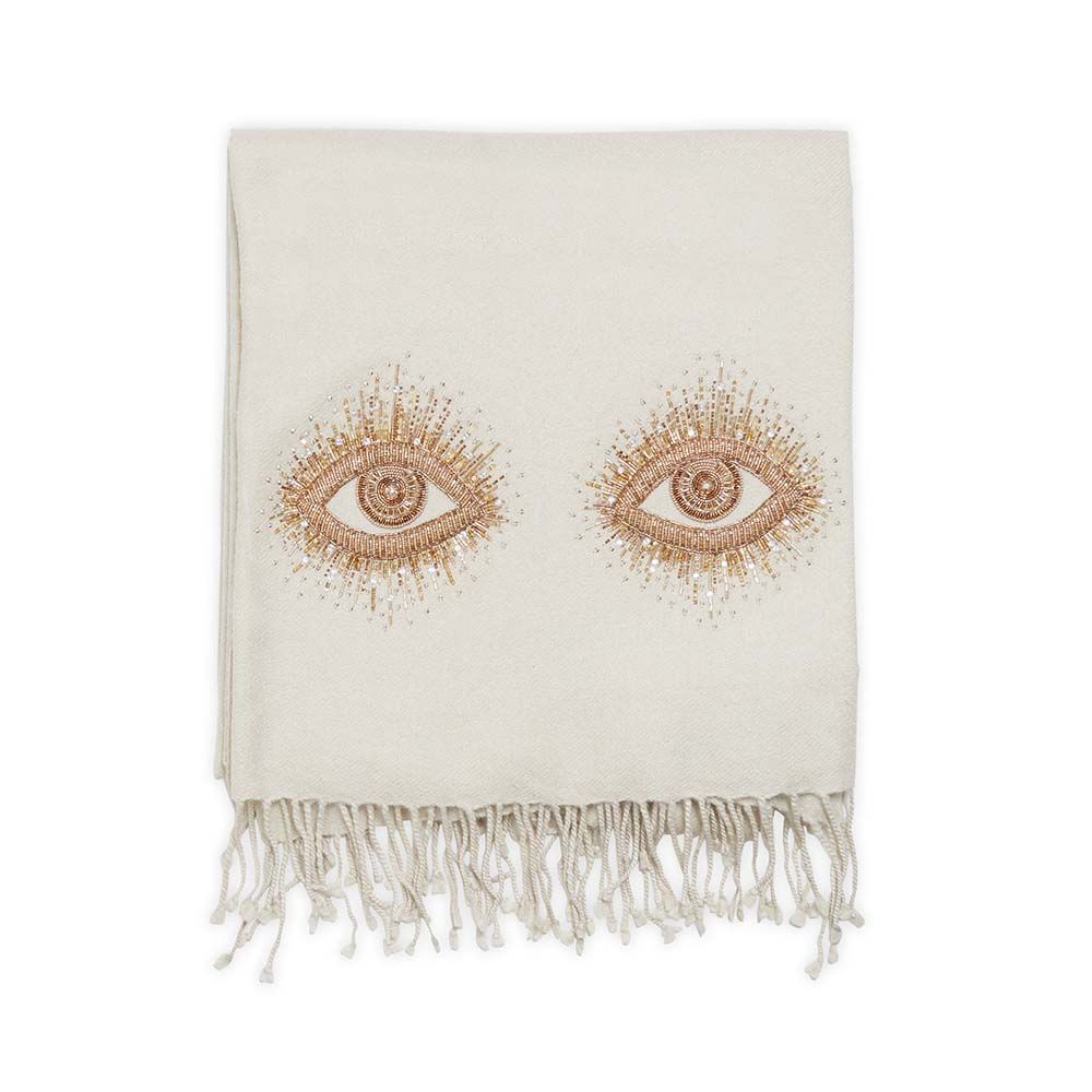 A luxurious, natural-toned hand-embroidered throw with golden accents