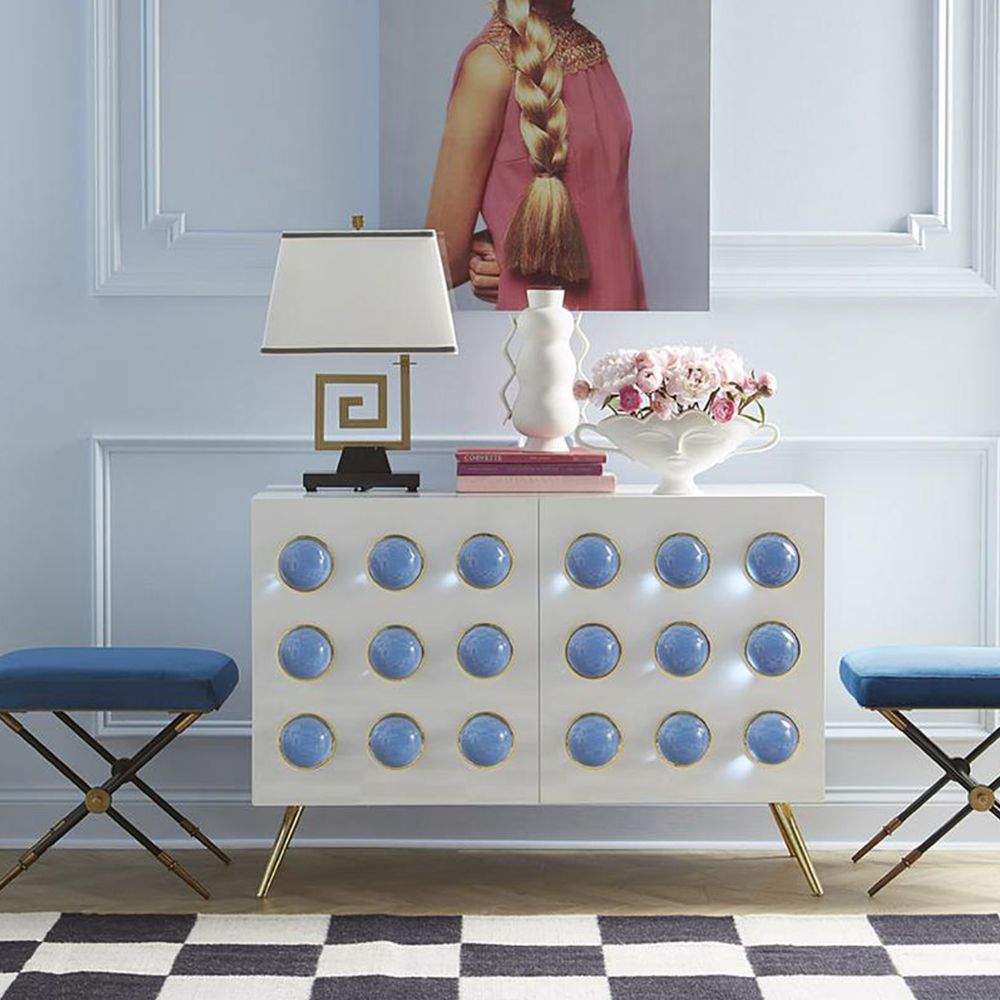 An exquisite bench with blue velvet and black and brass legs