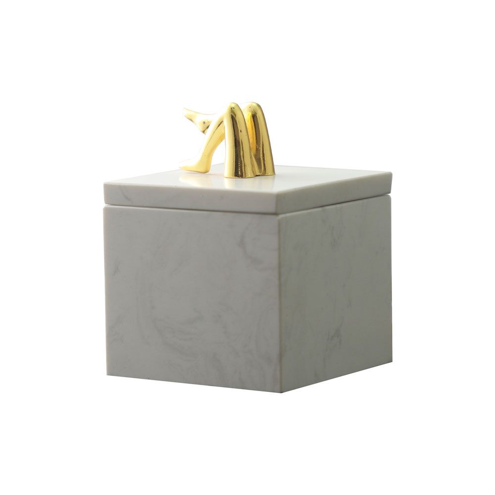 White marble storage jar with brass legs detail on top
