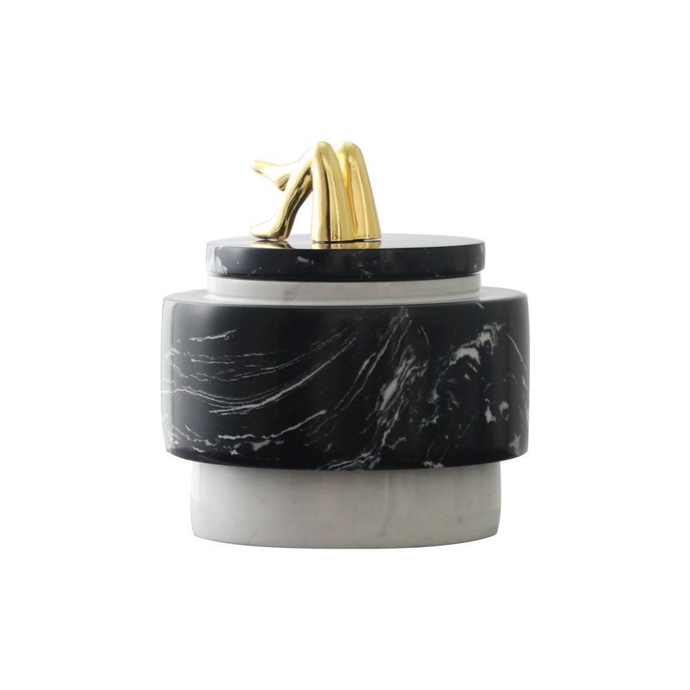 Black marble storage jar with brass legs detail on top